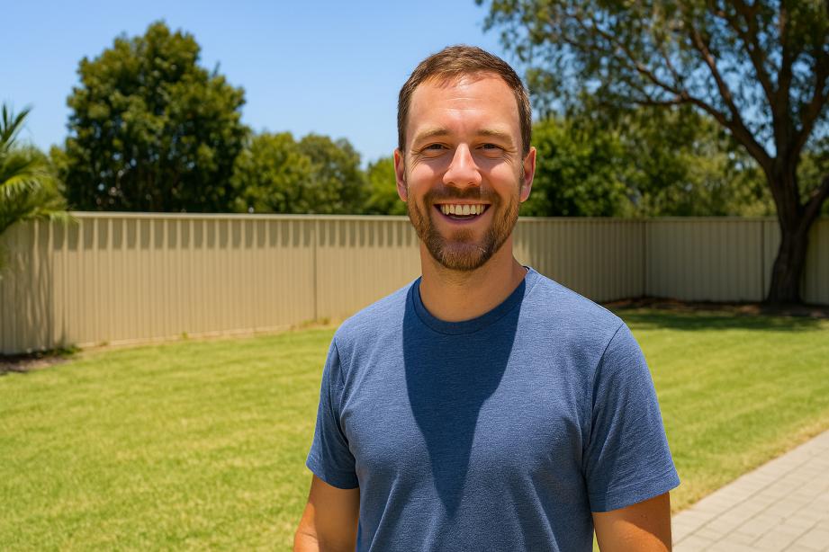 Customer smiling in freshly mowed backyard